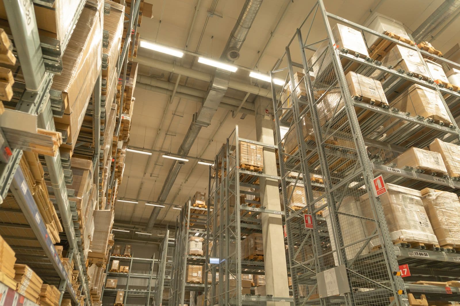 Warehouse shelving stocked with pallets of product